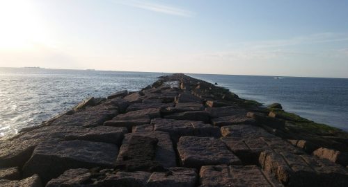 large granite slabs stretching out into the gulf of mexico to create the port aransas jetty