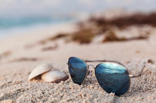 Blue sunglasses at sandy beach
